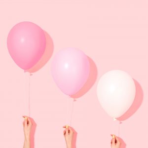 Three pink birthday balloons