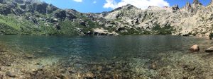 Panoramic picture of a lake in Corsica surrounded by Mountains