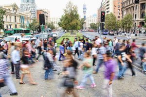 Blurry image of people walking on a crowded street