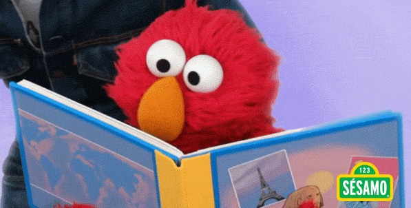 Elmo reads a book in spanish