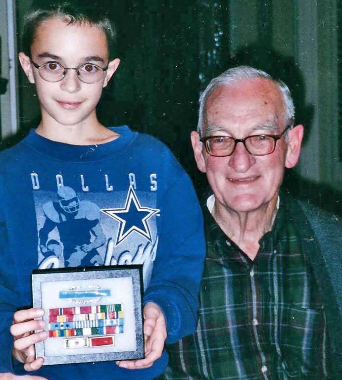 Robert Teater giving Kevin Teater military medals