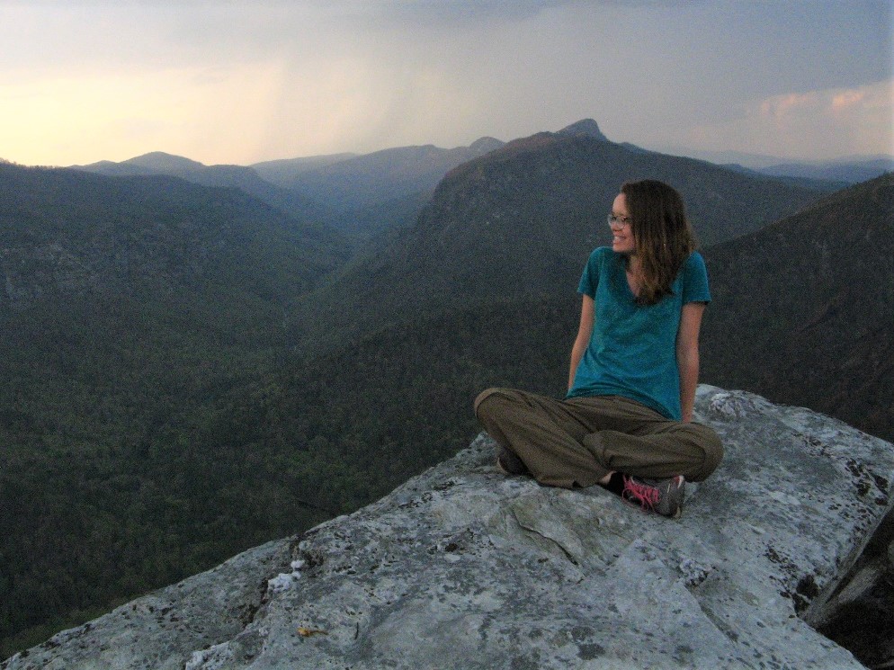 Maya sitting on rock on gorge