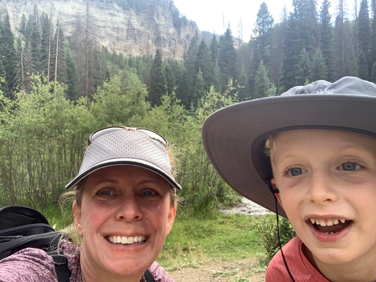 Kristie and her son out hiking with mountain in background