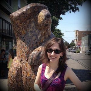 Jane Marie Ford in front of Bear carving.