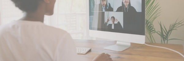 Woman on computer chatting with three people.