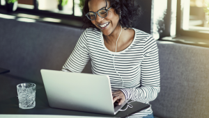 woman sitting on computer smiling