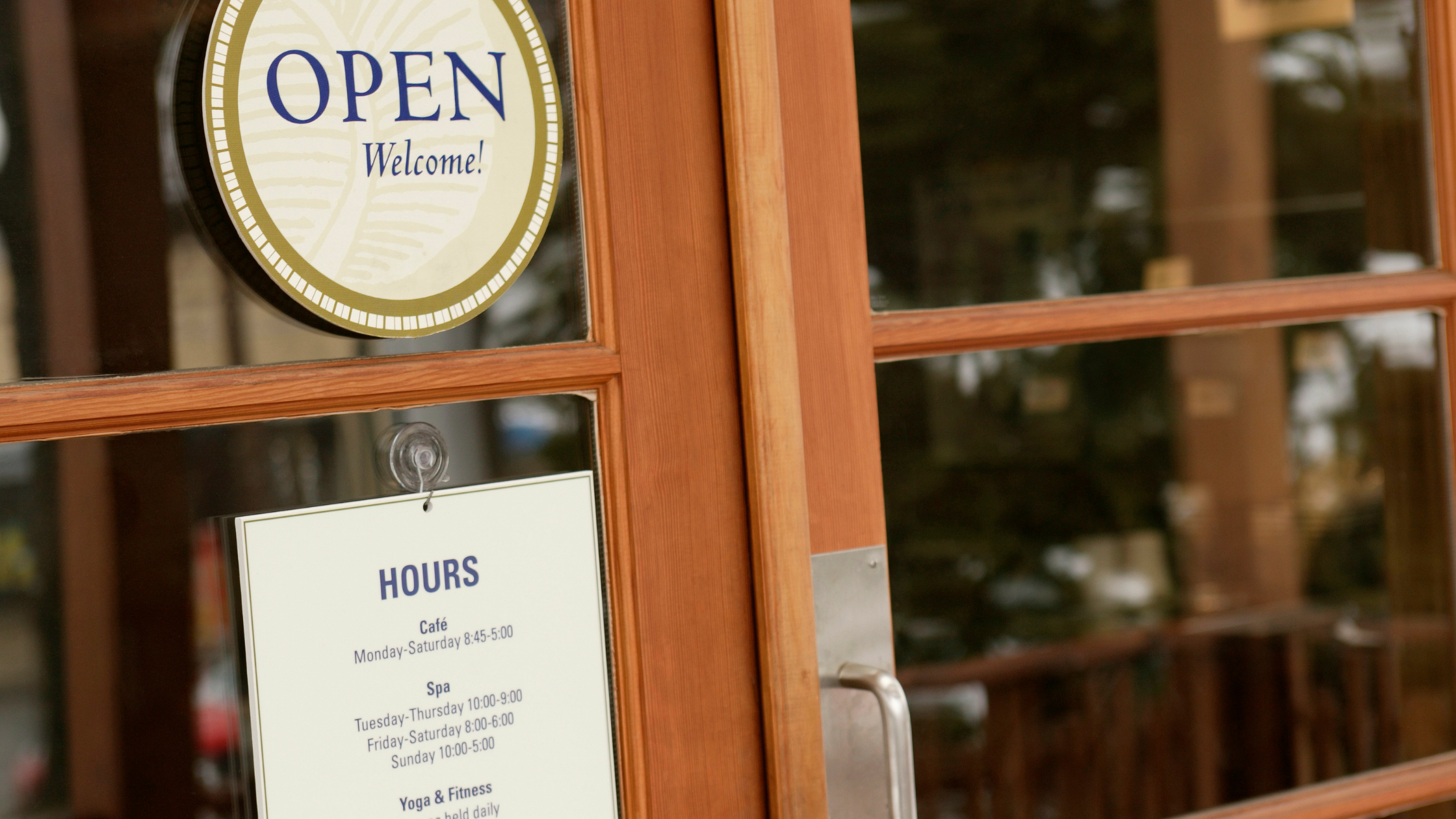 Open sign on a brown door