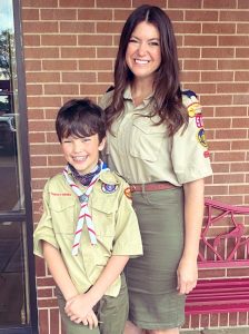 young boy scout with female troop leader