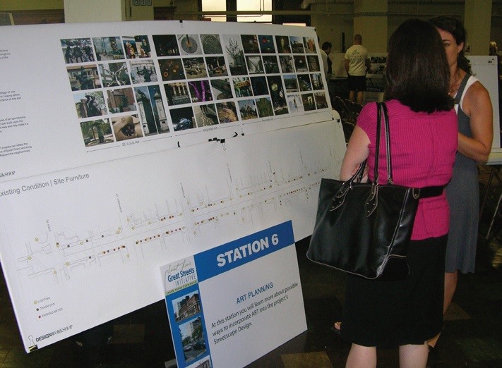 People at community meeting reviewing board