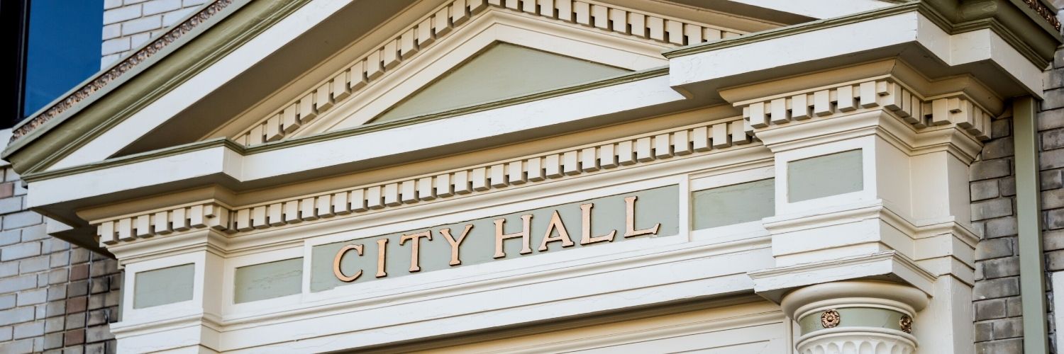 Exterior of classic style building with City Hall sign