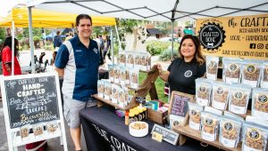 Two people selling honey at Farmers' Market