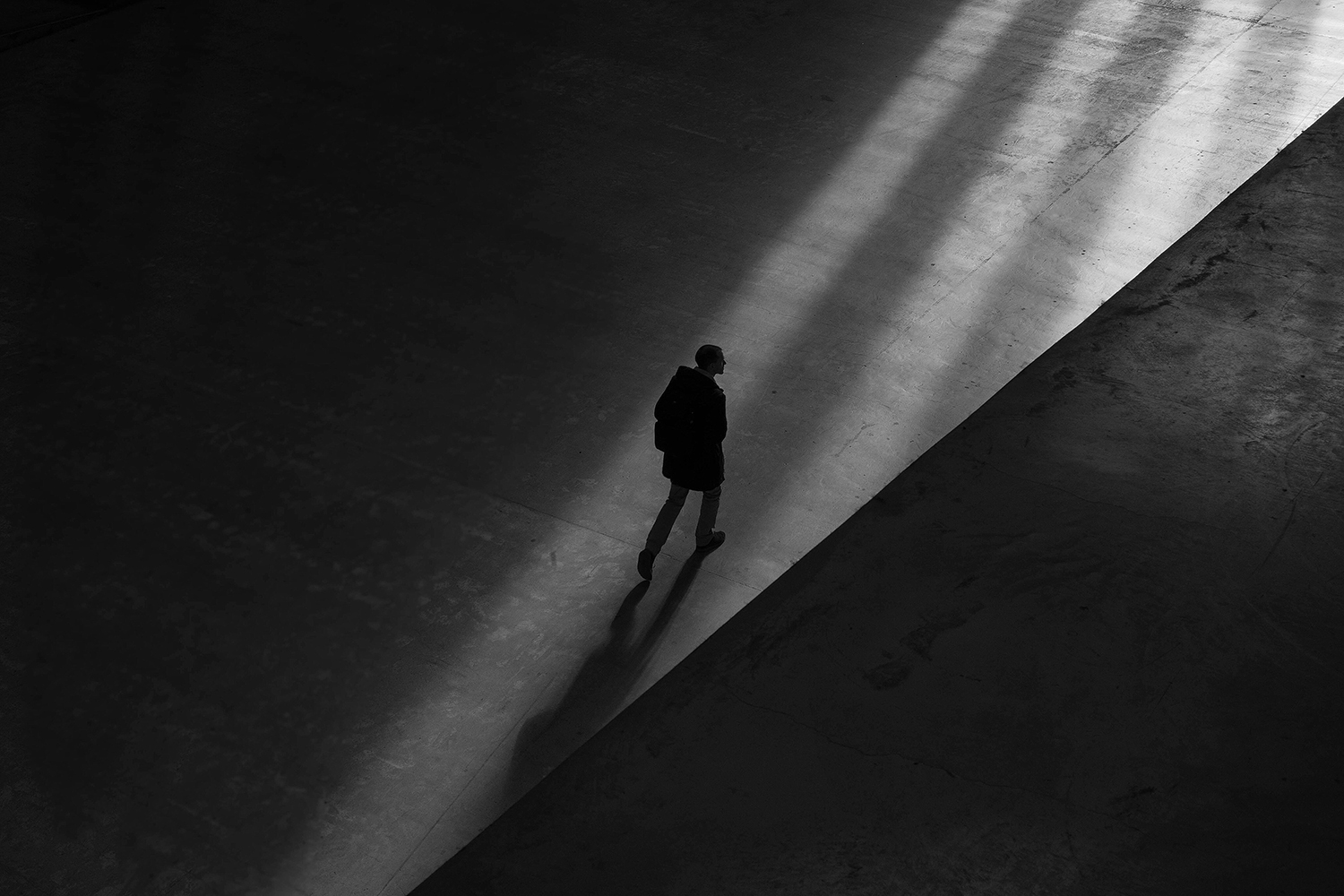 A man walking alone with shadows