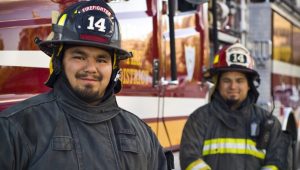 Picture of two firefighters looking at the camera