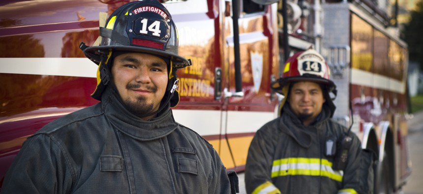 Picture of two firefighters looking at the camera