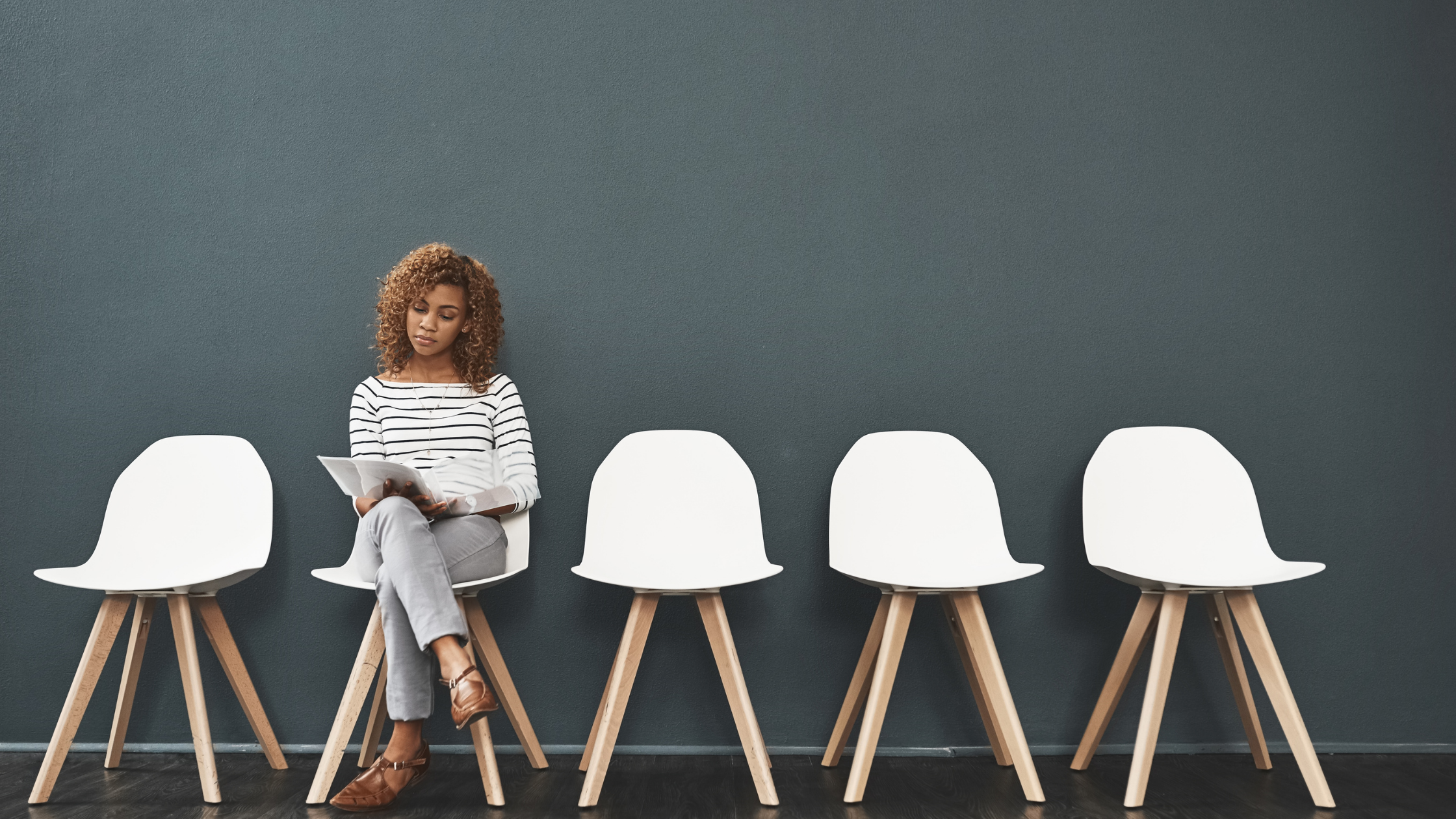 person waiting for an interview sitting on white chair