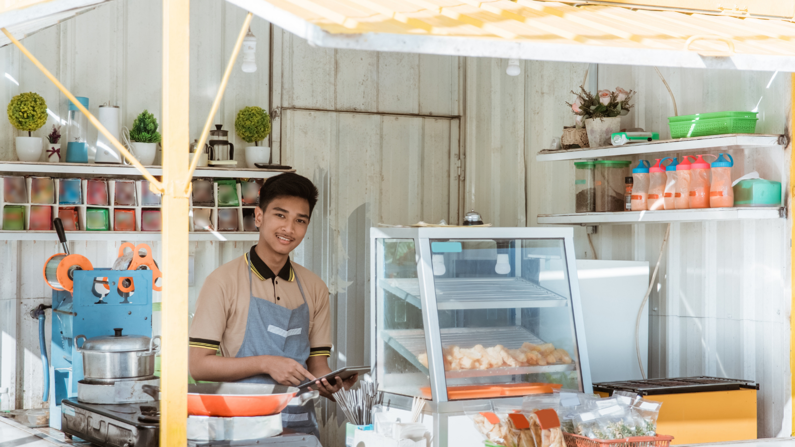 Person smiling at camera behind booth