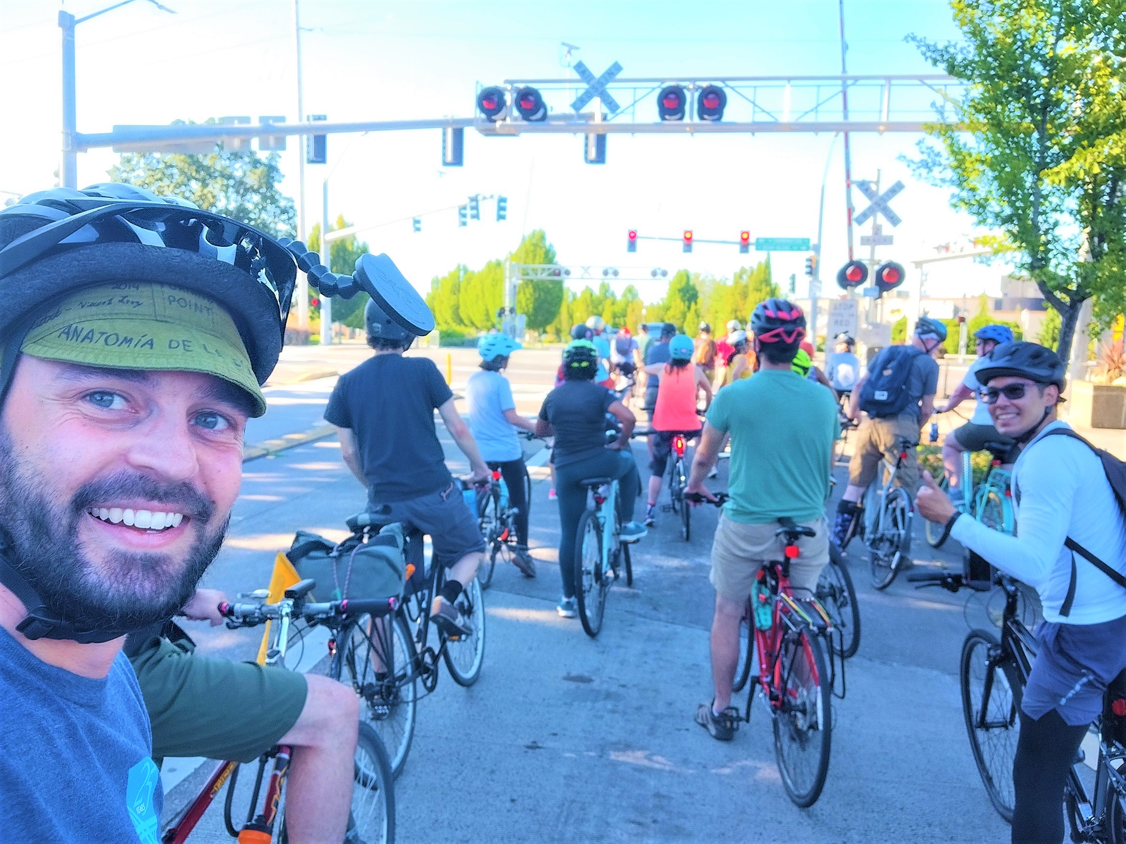 People biking down a suburban street