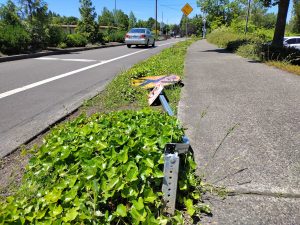 A roadway sign knocked down after a driver ran it over.