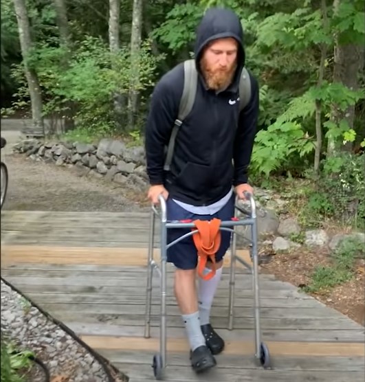 Mike Posner using a walker