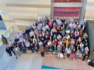 Photo from balcony looking down on at least 100 local government professionals at the Phoenix Convention Center.