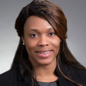 Headshot of black woman with long, dark, brown hair, and wearing a dark top.