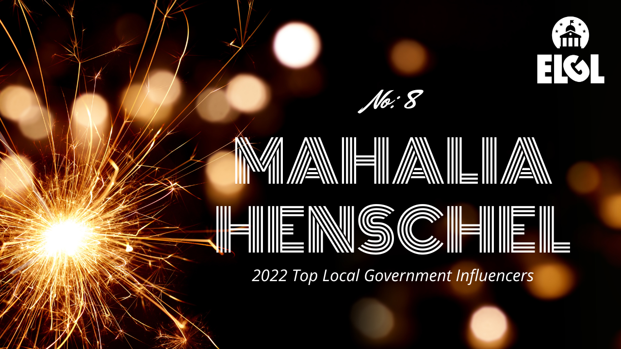 Gold firework sparkler and gold reflection spots on black background. White ELGL logo in upper right. Additional white text says "No. 8 Mahalia Henschel 2022 Top Local Government Influencers."