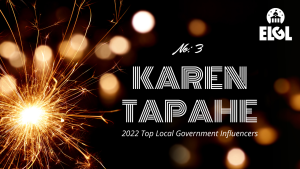 Gold firework sparkler and gold reflection spots on black background. White ELGL logo in upper right. Additional white text says "No. 3 Karen Tapahe 2022 Top Local Government Influencers."