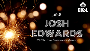 Gold firework sparkler and gold reflection spots on black background. White ELGL logo in upper right. Additional white text says "No. 2 Josh Edwards 2022 Top Local Government Influencers."