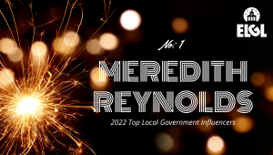 Gold firework sparkler and gold reflection spots on black background. White ELGL logo in upper right. Additional white text says "No. 1 Meredith Reynolds 2022 Top Local Government Influencers."