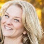 A headshot of a white woman standing against a colorful background