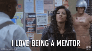 Rosa from Brooklyn 99 show, standing in the precinct with text, "I love being a mentor."