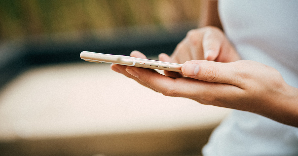 A close-up of a hand holding a smartphone.