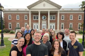 A group of people stand outside Windsor, Connecticut, City Hall on #CityHallSelfie Day 2022.