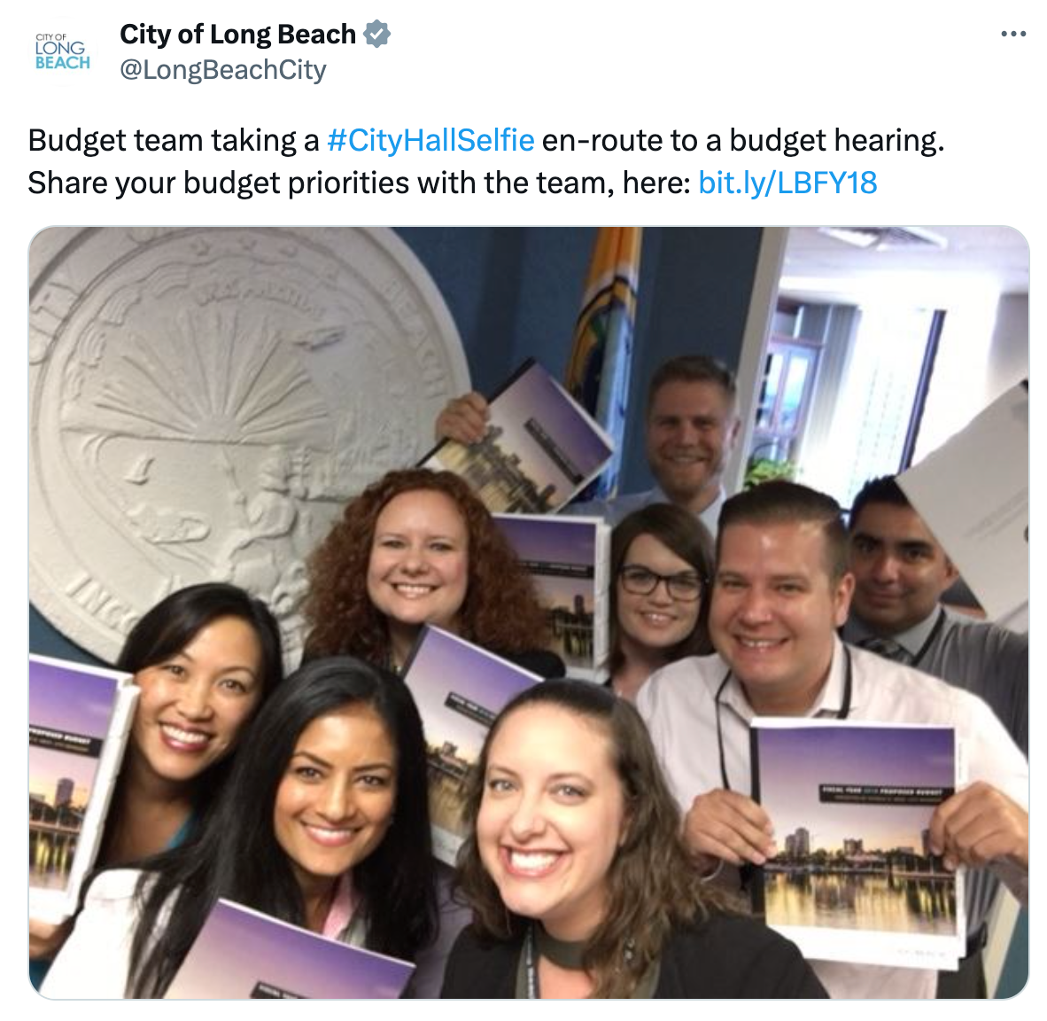 A tweet showing Long Beach, CA employees taking a City Hall Selfie en route to a budget hearing.