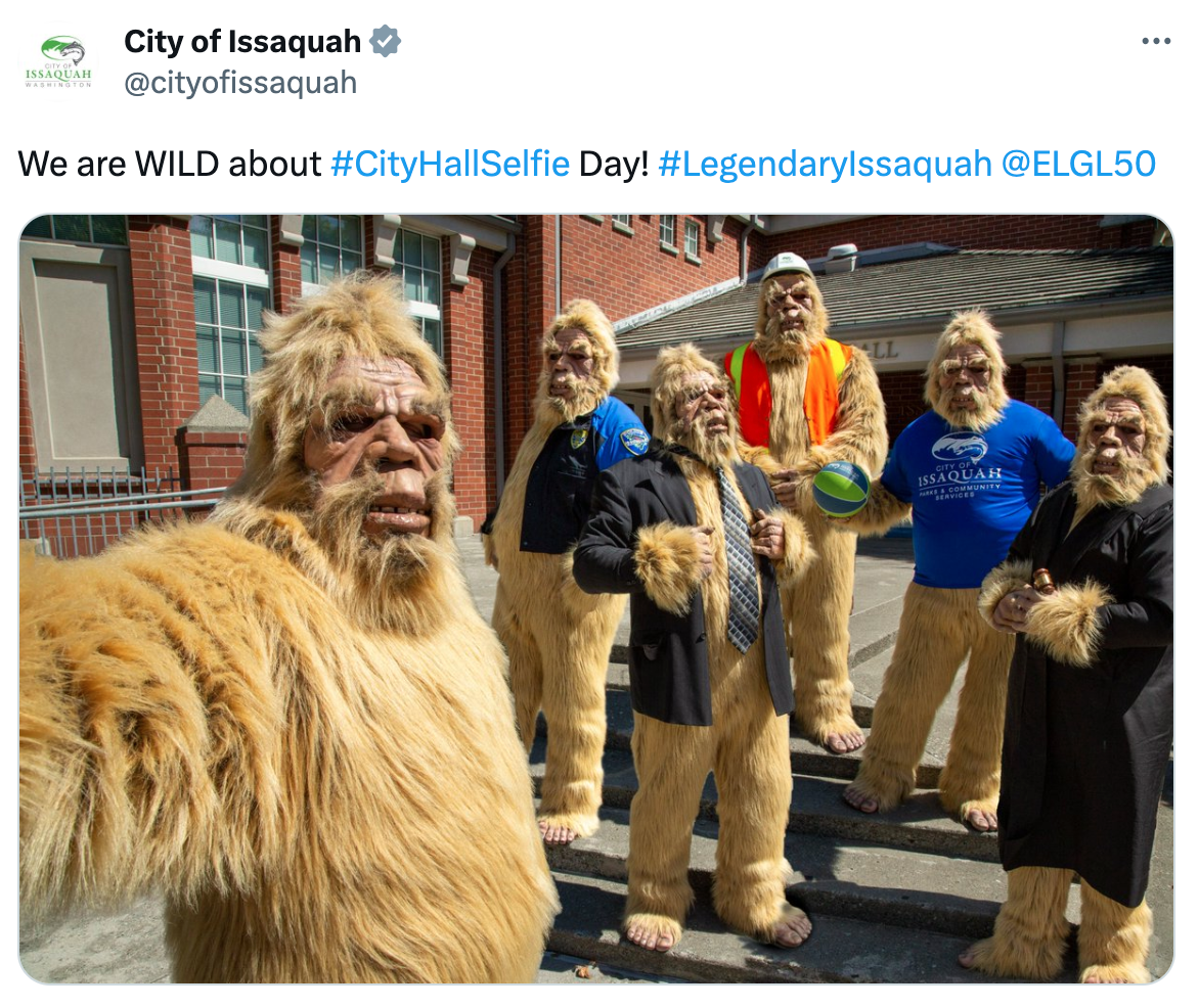 A tweet showing several Sasquatches taking a selfie outside Issaquah, WA City Hall.