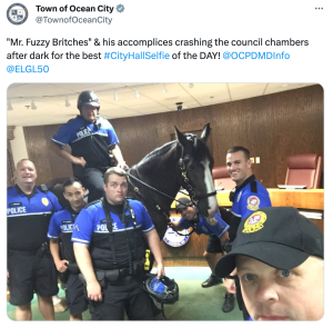 A tweet showing a City Hall Selfie from police officers and a police horse in Ocean City, MD.