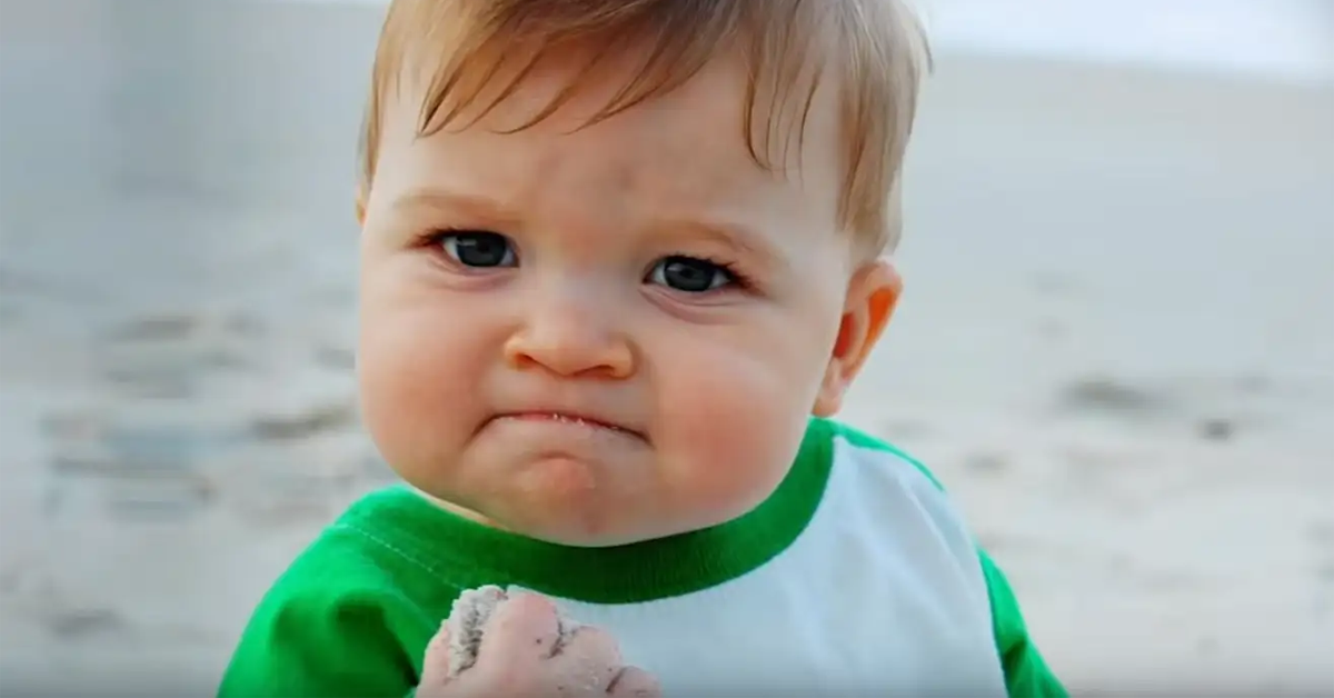 The Success Kid meme, showing a toddler on a beach with a determined expression and a handful of sand.