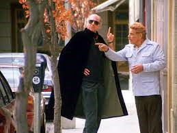 A scene from "Seinfeld" where Larry David wears a cape while speaking to Jerry Stiller.