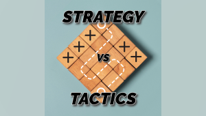 A gameboard with Xs and dotted lines with the words "Strategy vs. Tactics" overlaid on it.