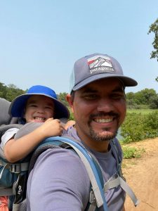 Matt with his kid hiking