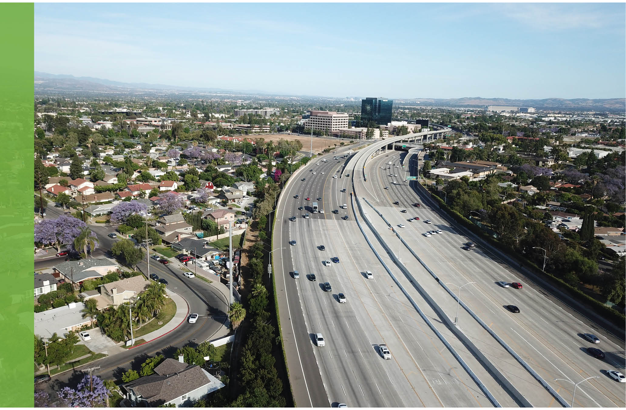 Noise Element Cover Photo: An overhead shot of the Santa Ana freeway. In the background are the Xerox Centre and purple jacarandas in bloom.