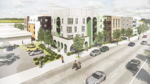 A photo rendering of a multifamily development adjacent to a busy street