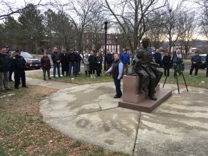 Andrew DiNapoli (center) stands behind the monument to his father as he thanks those who gathered for the December 22 wreath-laying ceremony.