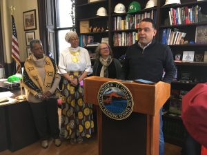 Holyoke Mayor Joshua A. Garcia reads a proclamation acknowledging the
contributions the African-American community during a Kwanzaa observance in his office December
28. Looking on (from left) are Theresa Cooper-Gordon, Ayanna Crawford and State Representative Pat
Duffy.