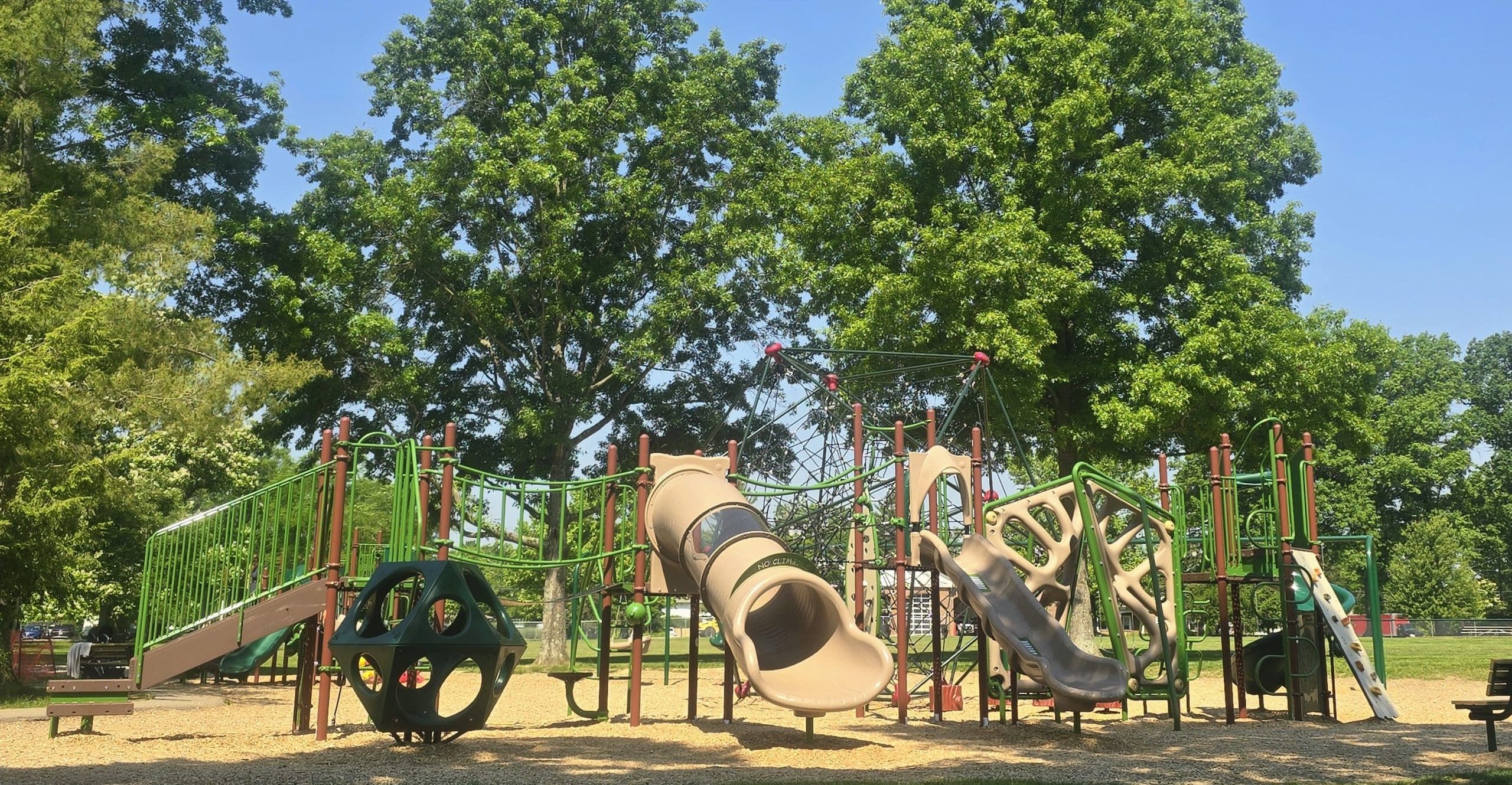 Stephan Field playground with tall trees in the background.