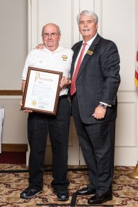 Mayor Patterson presents Larry Schlea with a Proclamation to recognize his 20,000 hours of service