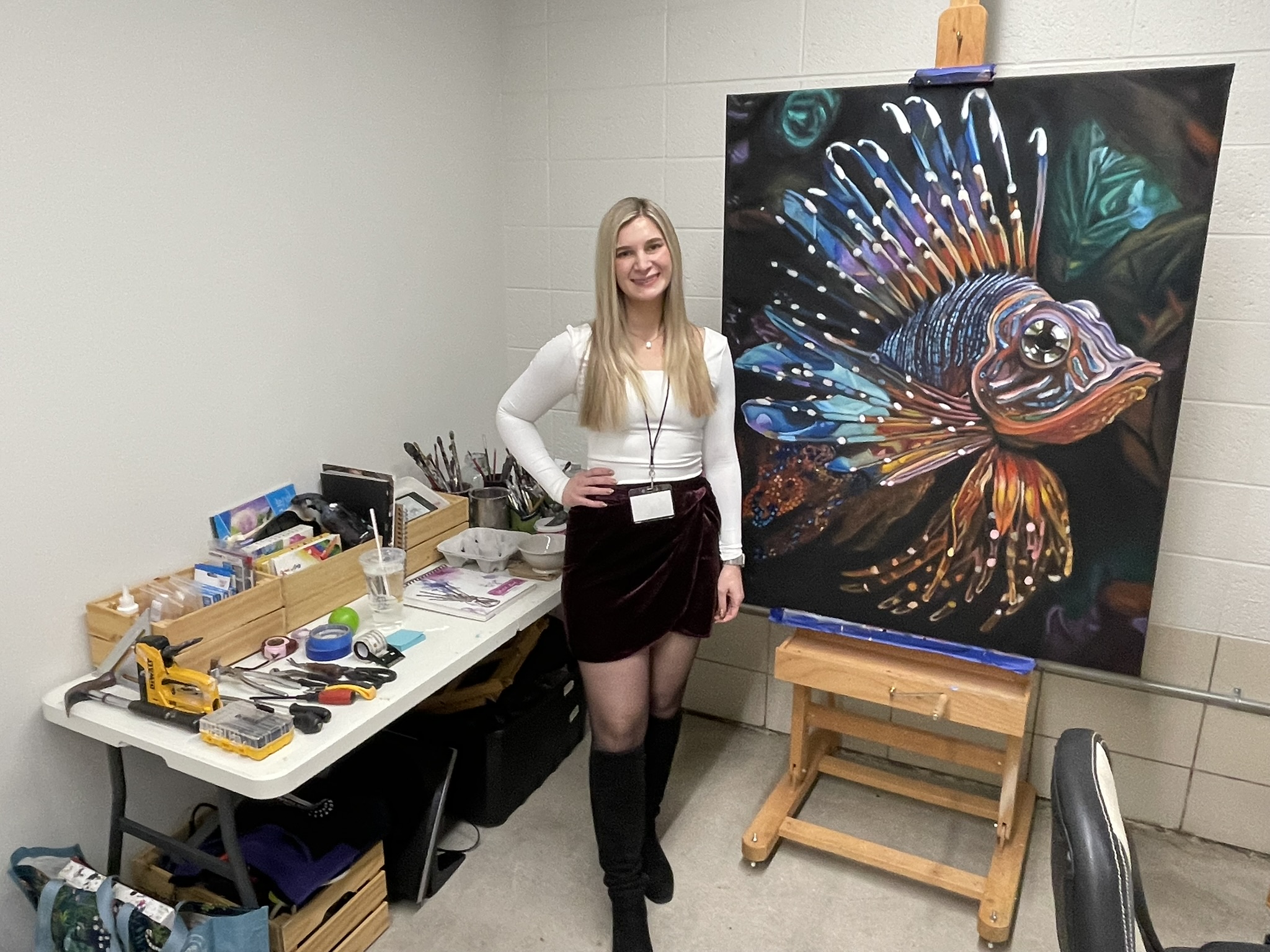 Artist Hadley with painting of a fish