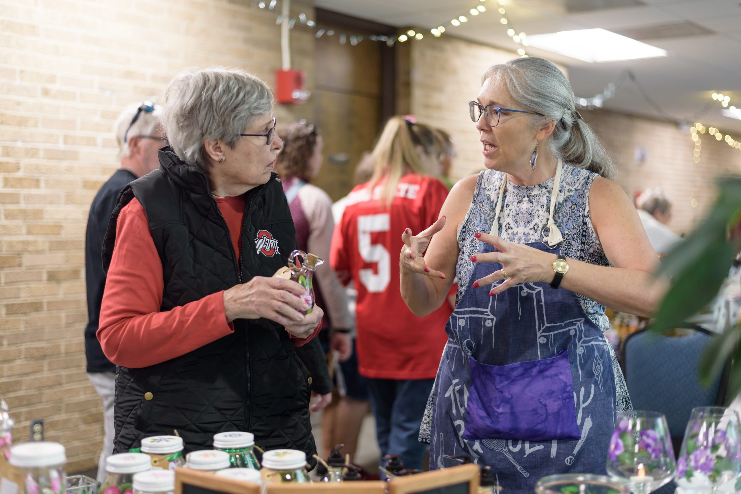 Shoppers making a purchase at a holiday vendor event