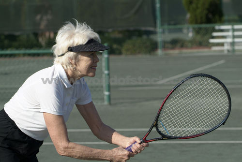 senior playing tennis