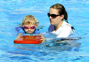 boy and swim teacher